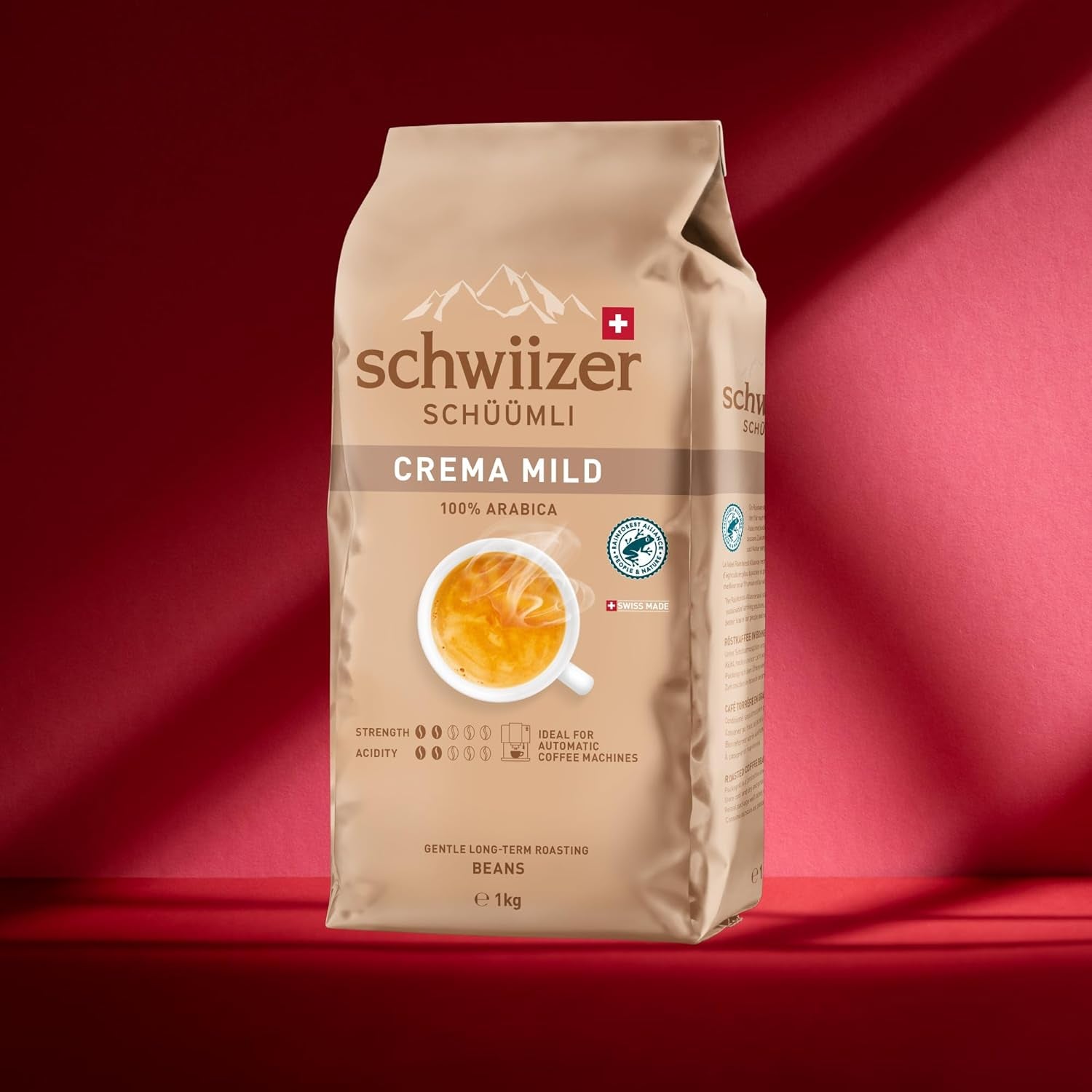 Schwiizer Schüümli Crema Mild, café en grano 100% Arábica fino, armonioso y suave, ideal para máquinas automáticas de espresso, concentración 2/5, tueste ligero, Rainforest Alliance, 1kg