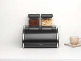 Brabantia Caja de pan para panecillos - Caja de almacenamiento compacta para encimera para pan, bagels y panecillos con tapa plana, acero resistente - tamaño mediano - negro mate Cajas para almacenar alimentos Naty Shop