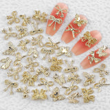 50Stück 3D Lazo Dorado Nail Charms Mariposa Nail Art Charms Legierung Bogen Nagel Charms Nägel Zubehör Schleife Nagelschmuck Metall Schleifen Schmetterling Nageldesign Nagelanhänger Nailart Strasssteine